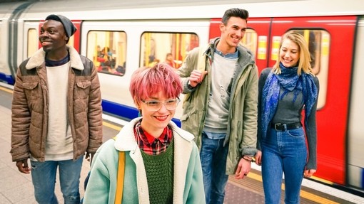 Multiracial group of hipster friends having fun in tube subway station - Urban friendship concept with young people walking together in city undergrou