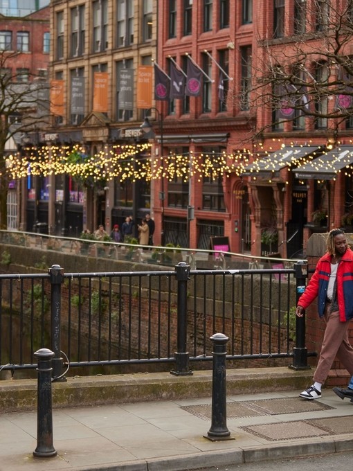 Two men chatting, exploring canal side shops.