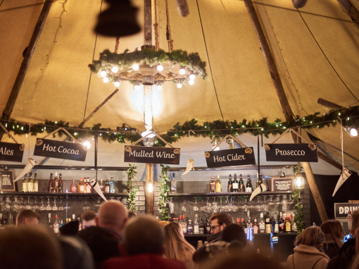 Crowd beneath a decorated marquee ceiling