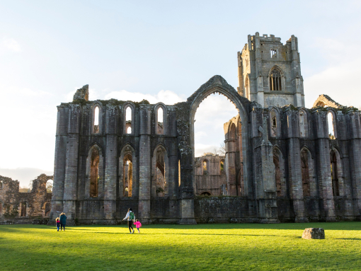 Visitors walking in the garden at Fountains Abbey and Studley Royal Water Garden, North Yorkshire