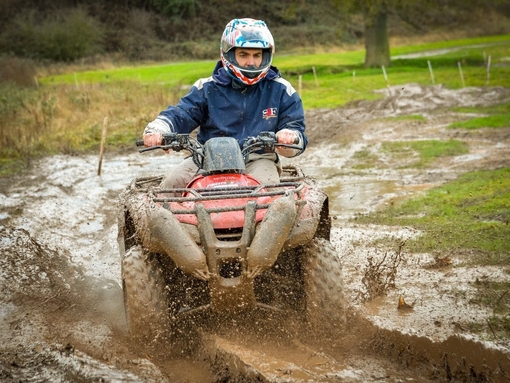 A man riding a quad bike on a muddy track near Stratford-upon-Avon