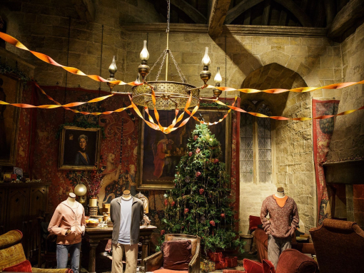 Christmas tree in Gryffindor common room with casual student clothes on dummies