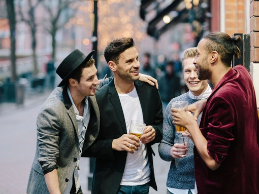 Gay couples standing together and having drinks