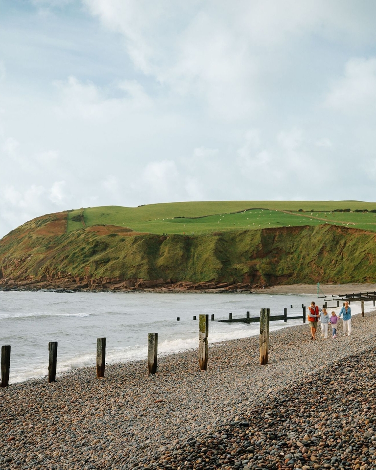 Family walking along a beach