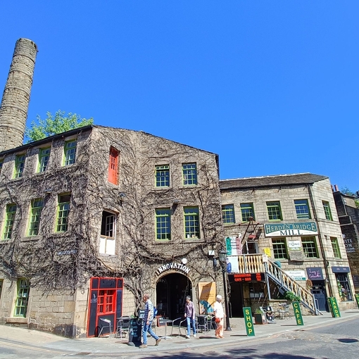 A village mill with passing pedestrians in the centre of an historic country village