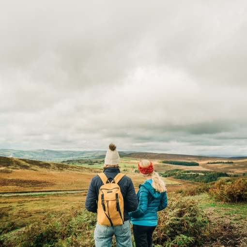 Two girls walking with panoramic views of greenery