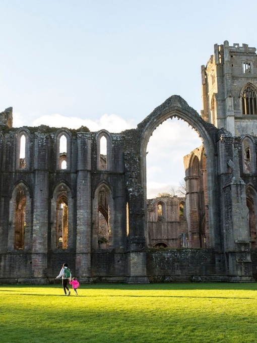 Visitors walking in the garden at Fountains Abbey and Studley Royal Water Garden, North Yorkshire