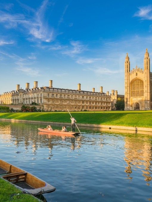 View of college in Cambridge with people punting on River