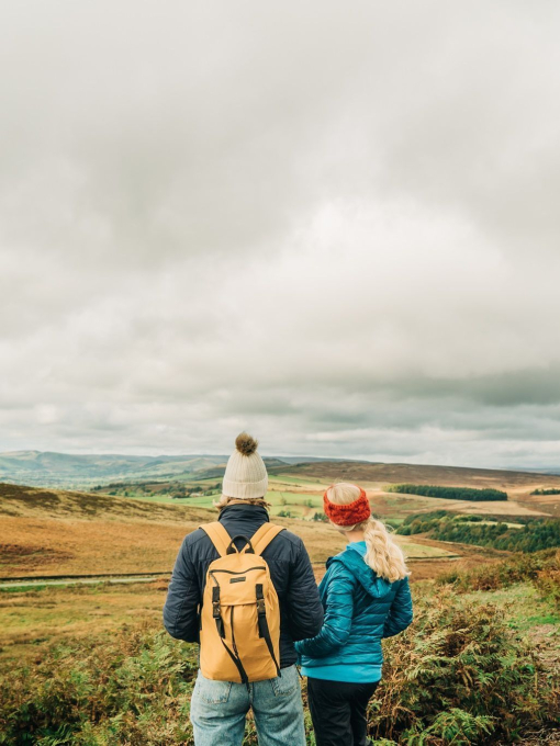 Two girls walking with panoramic views of greenery