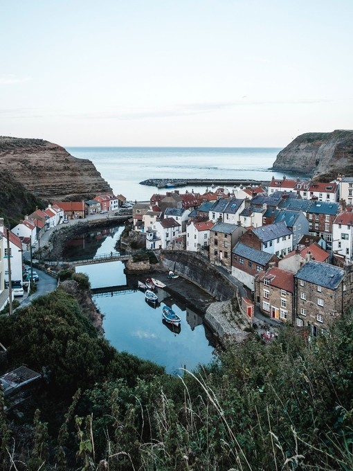 Aerial view of harbour, with boats, and village