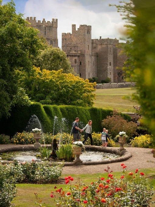 Family walking through the gardens of a castle