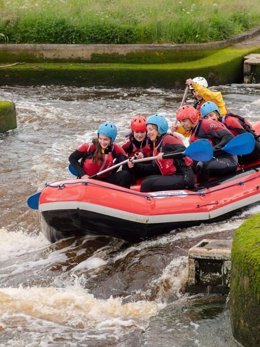 Group of people white water rafting