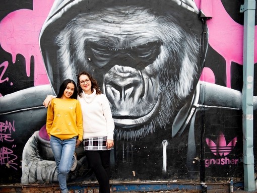 two people stand in front of Gorilla artwork by Gnasher
