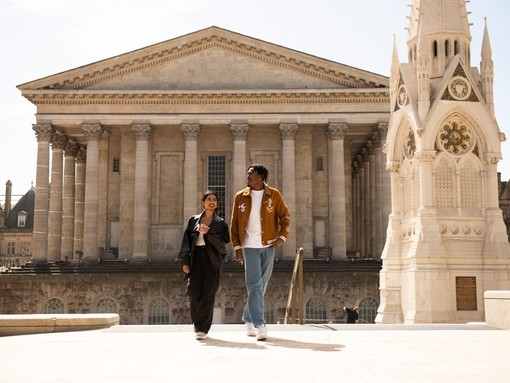 A couple strolling through an ornate English Town Square