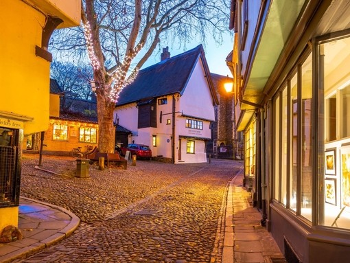 A pretty village square with cobbled streets at dusk