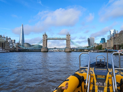 Group of people on board a speed boat on a city river